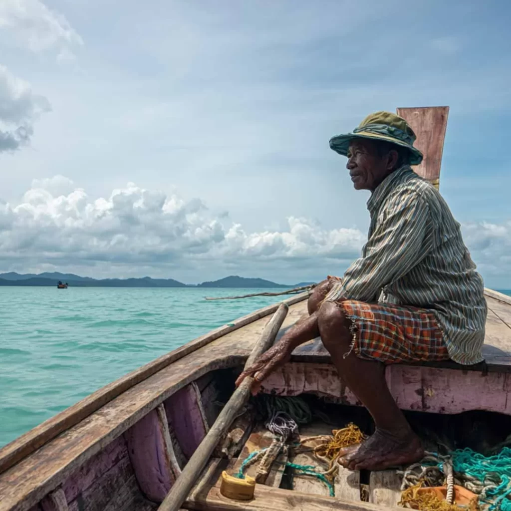 Local fisherman taking a break in his day of work on the Andaman sea - Koh Lanta Yai